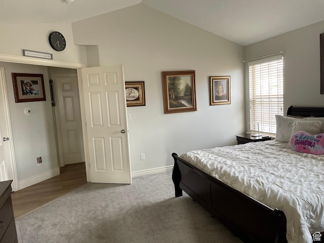bedroom with baseboards, carpet flooring, and vaulted ceiling