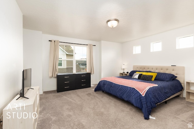 bedroom featuring light carpet