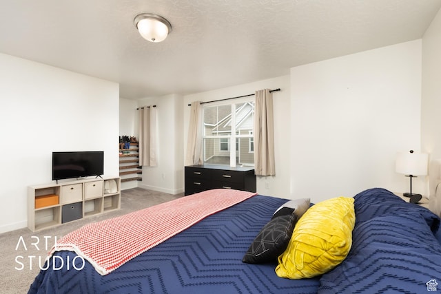 bedroom featuring baseboards and carpet