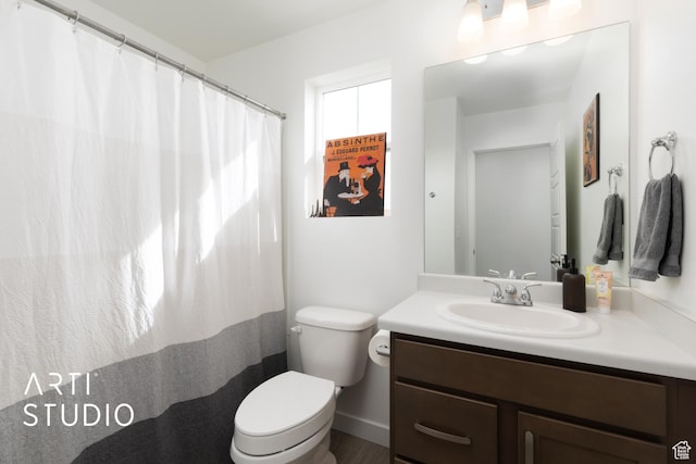 bathroom featuring toilet and vanity