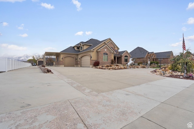 13053 S 1300 W, Riverton, UT 84065 - view of front facade with driveway, brick siding, and an attached garage
