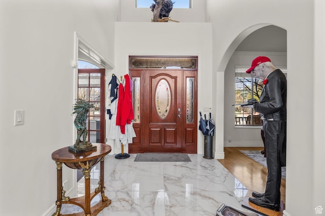 13053 S 1300 W, Riverton, UT 84065 - foyer featuring arched walkways, baseboards, marble tiled flooring, and a high ceiling