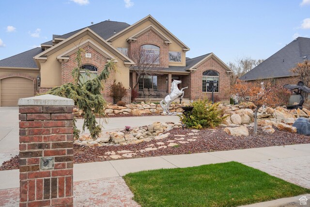 13053 S 1300 W, Riverton, UT 84065 - traditional-style home featuring brick siding, an attached garage, and concrete driveway