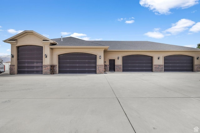 13053 S 1300 W, Riverton, UT 84065 - view of front facade featuring stucco siding, brick siding, driveway, and a garage