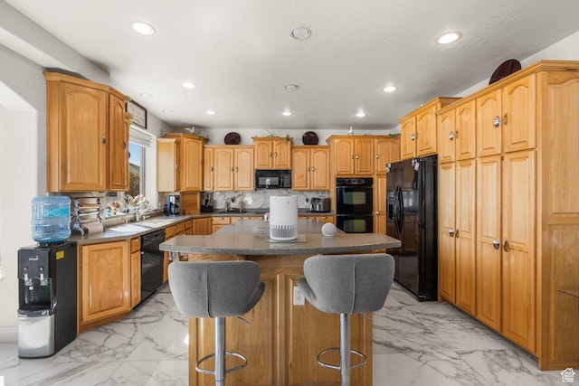13053 S 1300 W, Riverton, UT 84065 - kitchen with black appliances, light marble finish floors, recessed lighting, a kitchen island, and a kitchen bar