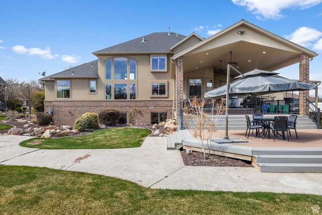 13053 S 1300 W, Riverton, UT 84065 - back of house featuring brick siding, stucco siding, a patio area, a ceiling fan, and a shingled roof