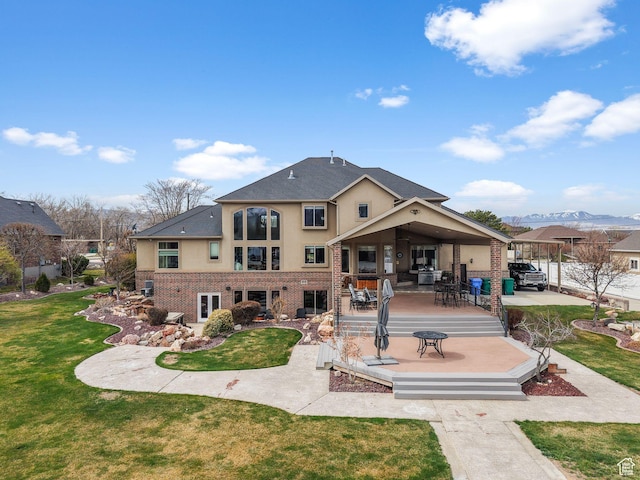 13053 S 1300 W, Riverton, UT 84065 - rear view of property with brick siding, stucco siding, a deck, a yard, and a patio area