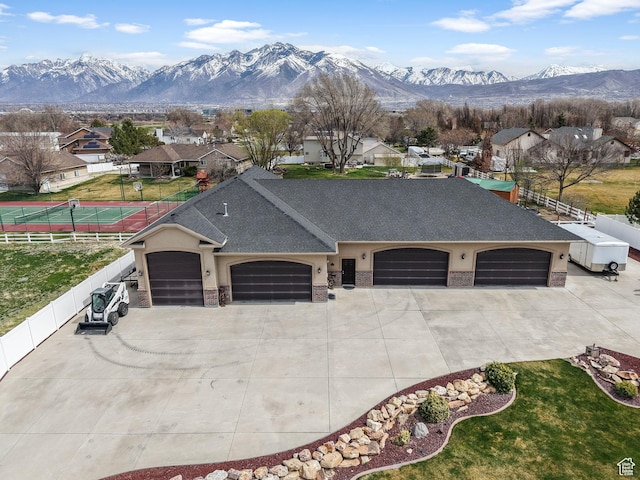 13053 S 1300 W, Riverton, UT 84065 - view of front of property with a garage, driveway, a mountain view, and stucco siding