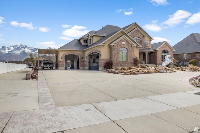 13053 S 1300 W, Riverton, UT 84065 - view of front of property featuring brick siding, a mountain view, and curved driveway