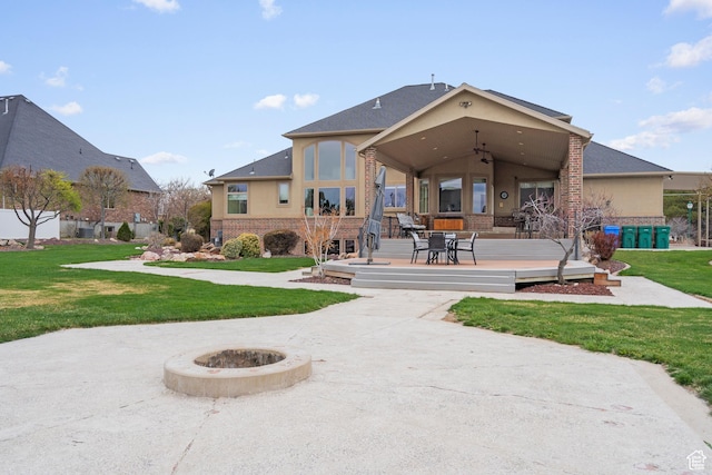 13053 S 1300 W, Riverton, UT 84065 - rear view of house featuring a ceiling fan, brick siding, a lawn, and a wooden deck