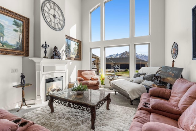 13053 S 1300 W, Riverton, UT 84065 - living room featuring carpet, a glass covered fireplace, and a high ceiling