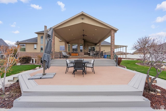 13053 S 1300 W, Riverton, UT 84065 - wooden terrace with outdoor dining area, a ceiling fan, and a yard