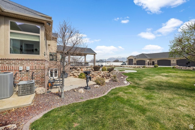 13053 S 1300 W, Riverton, UT 84065 - view of grassy yard with central AC, a patio area, and a mountain view