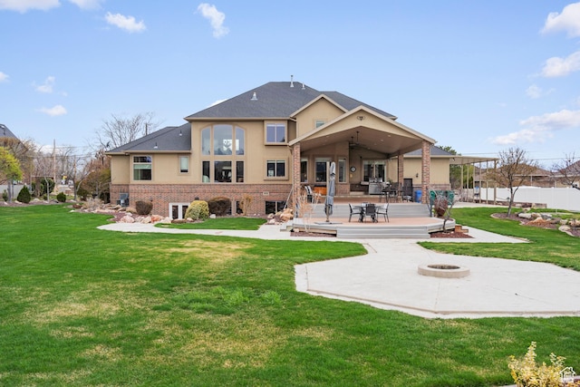 13053 S 1300 W, Riverton, UT 84065 - back of house with an outdoor fire pit, a patio area, stucco siding, a ceiling fan, and brick siding
