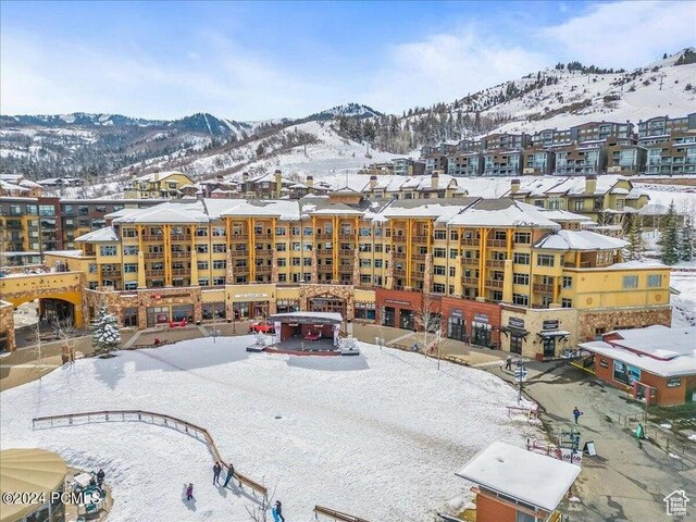 snowy aerial view featuring a mountain view