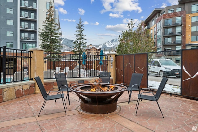 3720 N Sundial Ct Unit B417, Park City, UT 84098 - view of patio featuring a fire pit, a mountain view, and fence
