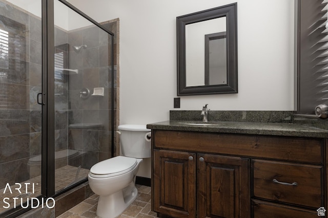 5055 Waterfall Dr, Pleasant View, UT 84414 - bathroom featuring toilet, vanity, a stall shower, and baseboards
