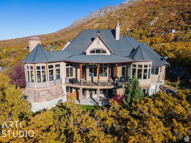 5055 Waterfall Dr, Pleasant View, UT 84414 - rear view of property with a patio, a sunroom, a chimney, and a mountain view