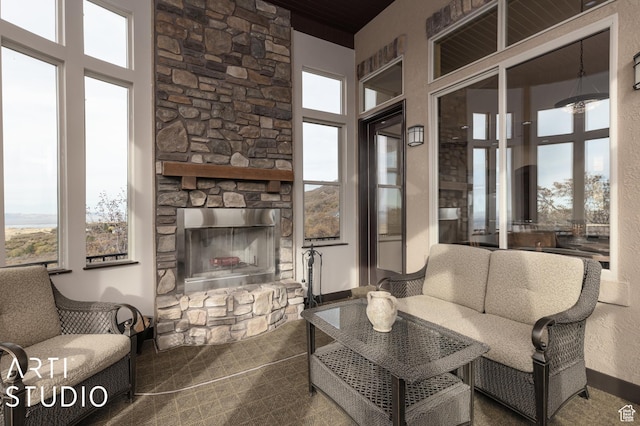 5055 Waterfall Dr, Pleasant View, UT 84414 - living area featuring a high ceiling, a stone fireplace, and a wealth of natural light
