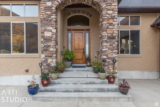 5055 Waterfall Dr, Pleasant View, UT 84414 - entrance to property with stone siding, roof with shingles, and stucco siding