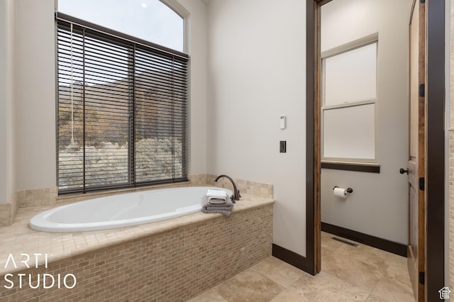 5055 Waterfall Dr, Pleasant View, UT 84414 - bathroom featuring baseboards, visible vents, and a bath