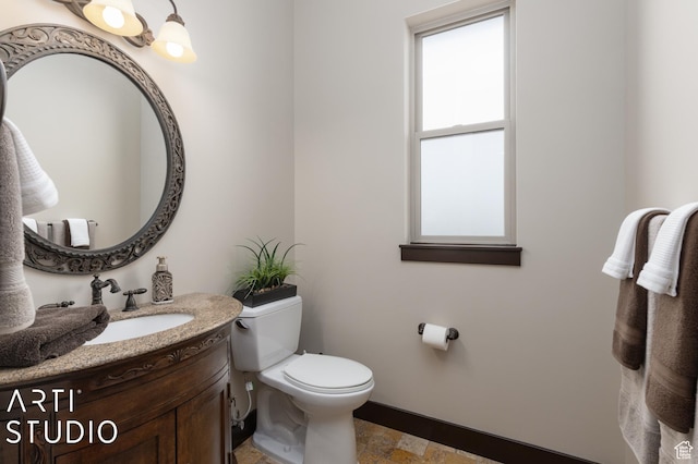 5055 Waterfall Dr, Pleasant View, UT 84414 - bathroom with baseboards, toilet, stone finish floor, and vanity