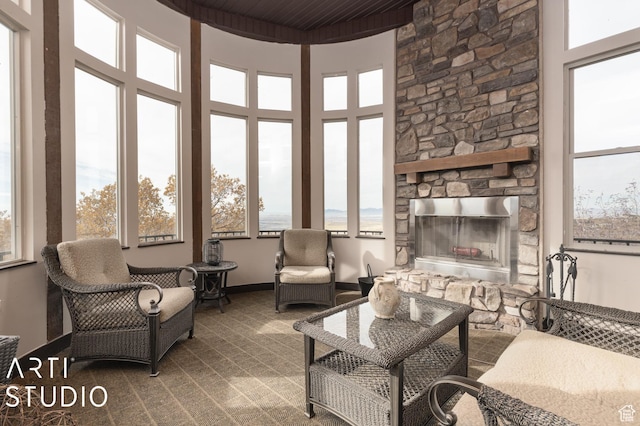 5055 Waterfall Dr, Pleasant View, UT 84414 - living room with a stone fireplace and a healthy amount of sunlight
