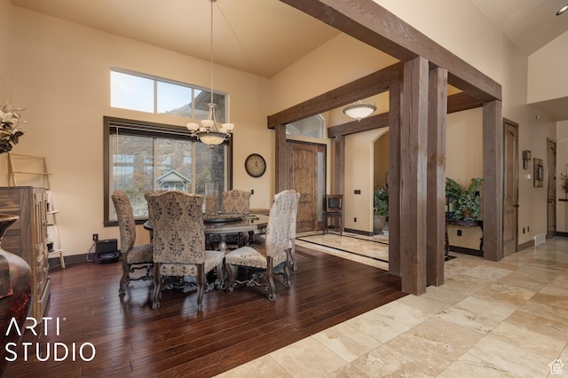 5055 Waterfall Dr, Pleasant View, UT 84414 - dining area featuring baseboards, a high ceiling, wood finished floors, and a chandelier