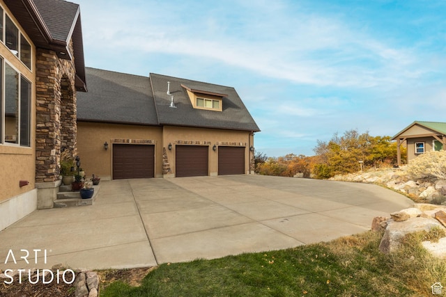 5055 Waterfall Dr, Pleasant View, UT 84414 - view of home's exterior with driveway, stucco siding, an attached garage, and stone siding