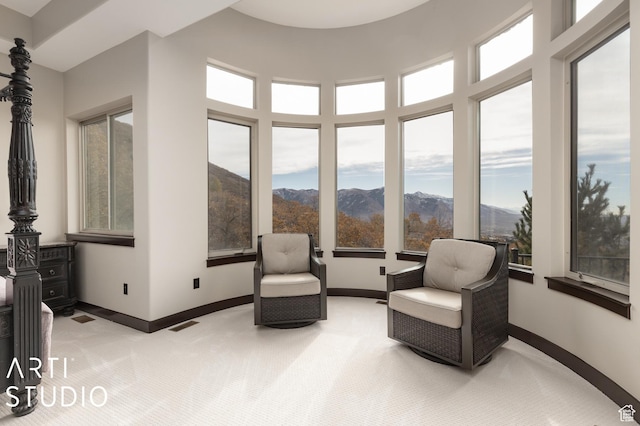 5055 Waterfall Dr, Pleasant View, UT 84414 - sitting room with baseboards, a high ceiling, light colored carpet, and a mountain view