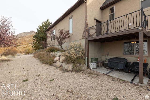 5055 Waterfall Dr, Pleasant View, UT 84414 - view of side of property featuring stucco siding and a mountain view