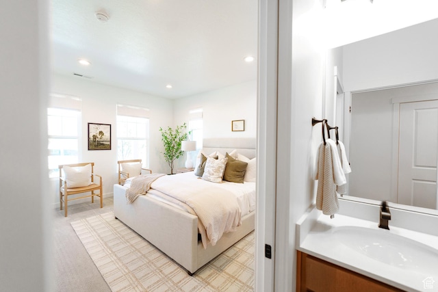 bedroom with visible vents, recessed lighting, and a sink