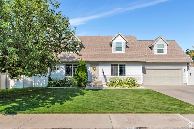 cape cod-style house featuring roof with shingles, concrete driveway, fence, a front lawn, and a garage