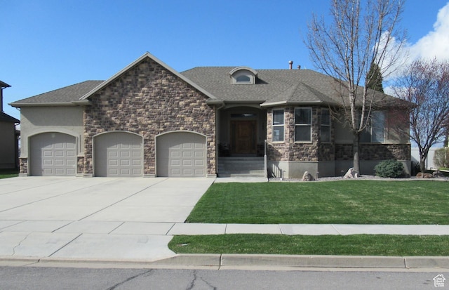 french country home with stone siding, driveway, a front lawn, and an attached garage