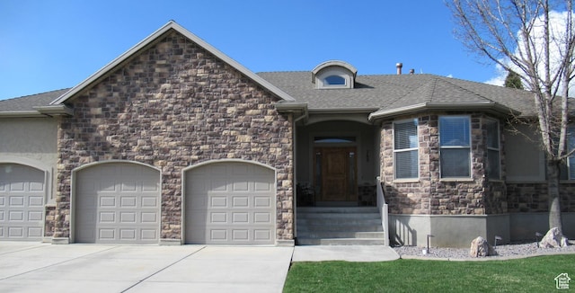 760 S Wellington Dr W, Kaysville, UT 84037 - view of front of house featuring stone siding, an attached garage, concrete driveway, and roof with shingles