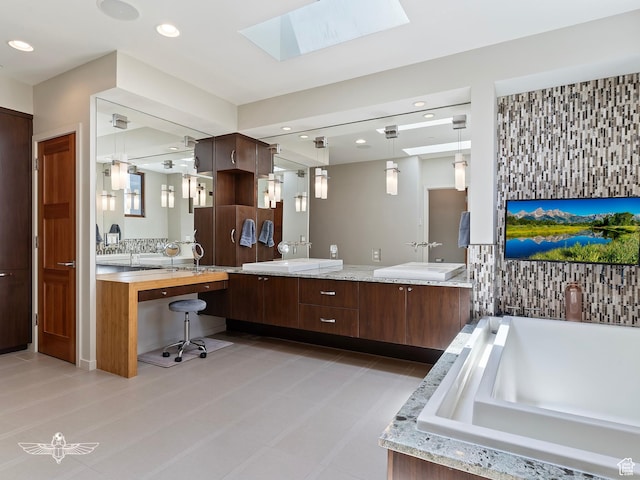 6639 E Chaparral Rd, Huntsville, UT 84317 - bathroom featuring recessed lighting, a skylight, double vanity, and a bathtub