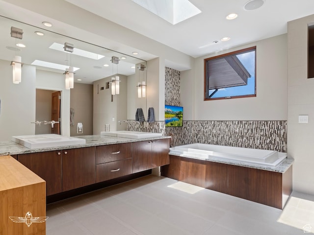 6639 E Chaparral Rd, Huntsville, UT 84317 - full bathroom featuring tile walls, a sink, a skylight, a garden tub, and double vanity