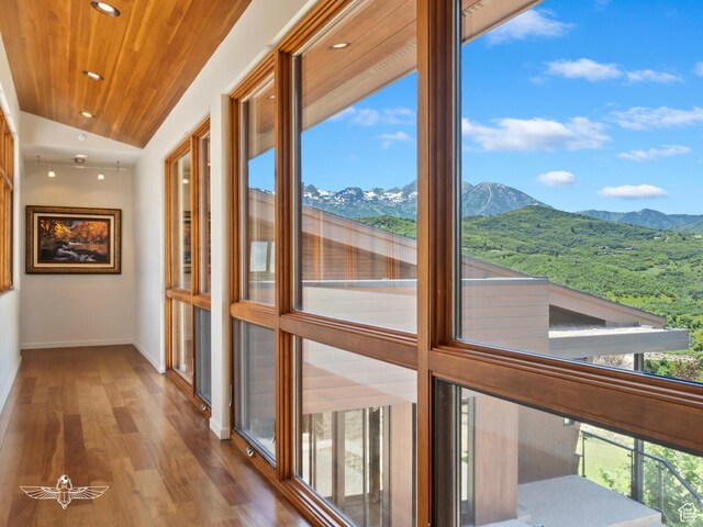 6639 E Chaparral Rd, Huntsville, UT 84317 - hall with vaulted ceiling, wood finished floors, a mountain view, and a healthy amount of sunlight