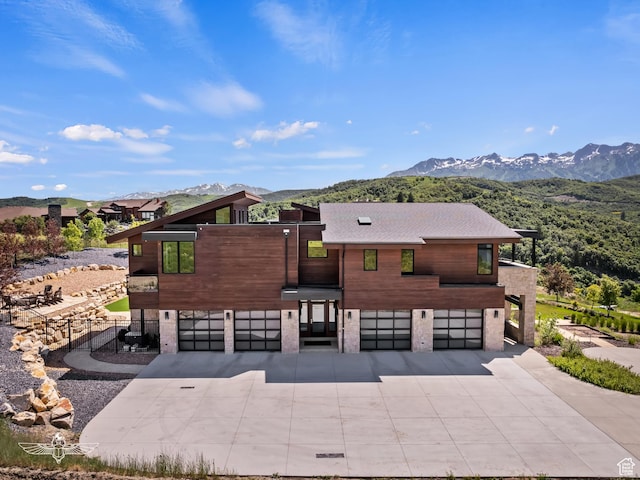 6639 E Chaparral Rd, Huntsville, UT 84317 - view of front of house with concrete driveway, a mountain view, and an attached garage