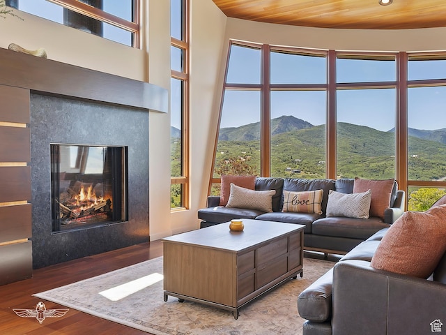 6639 E Chaparral Rd, Huntsville, UT 84317 - living area with wooden ceiling, wood finished floors, a mountain view, and a glass covered fireplace