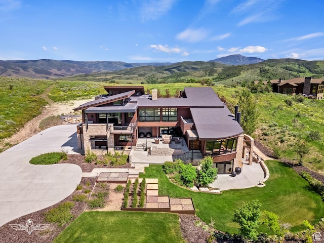 6639 E Chaparral Rd, Huntsville, UT 84317 - rear view of property featuring a chimney, stone siding, a patio, and a mountain view