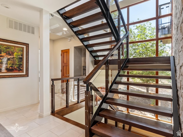 6639 E Chaparral Rd, Huntsville, UT 84317 - staircase with baseboards, visible vents, and tile patterned flooring