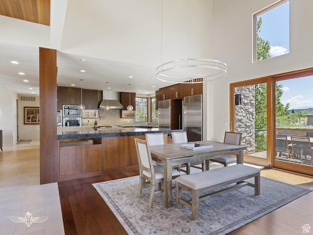 6639 E Chaparral Rd, Huntsville, UT 84317 - dining area with visible vents, recessed lighting, a towering ceiling, and light wood-type flooring