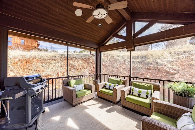 sunroom featuring an outdoor hangout area, ceiling fan, and beamed ceiling