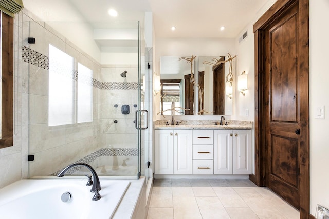 bathroom with a stall shower, a garden tub, tile patterned flooring, visible vents, and double vanity