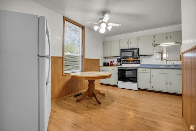 410 N 175 E, North Salt Lake, UT 84054 - kitchen featuring a sink, wood walls, light wood-type flooring, wainscoting, and white appliances