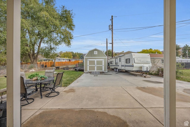 410 N 175 E, North Salt Lake, UT 84054 - view of patio / terrace featuring fence, outdoor dining area, an outdoor structure, and a shed