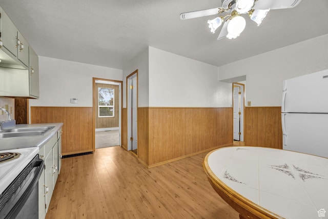 410 N 175 E, North Salt Lake, UT 84054 - kitchen featuring a wainscoted wall, light wood finished floors, a ceiling fan, a sink, and freestanding refrigerator
