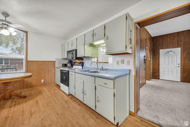 410 N 175 E, North Salt Lake, UT 84054 - kitchen featuring a sink, a ceiling fan, black microwave, wooden walls, and electric range