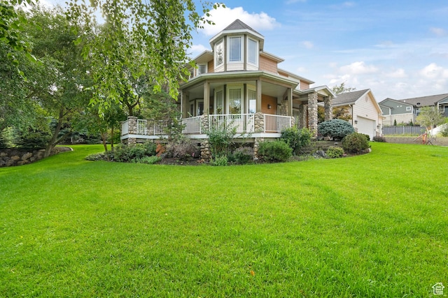 exterior space featuring a garage, a porch, and a yard